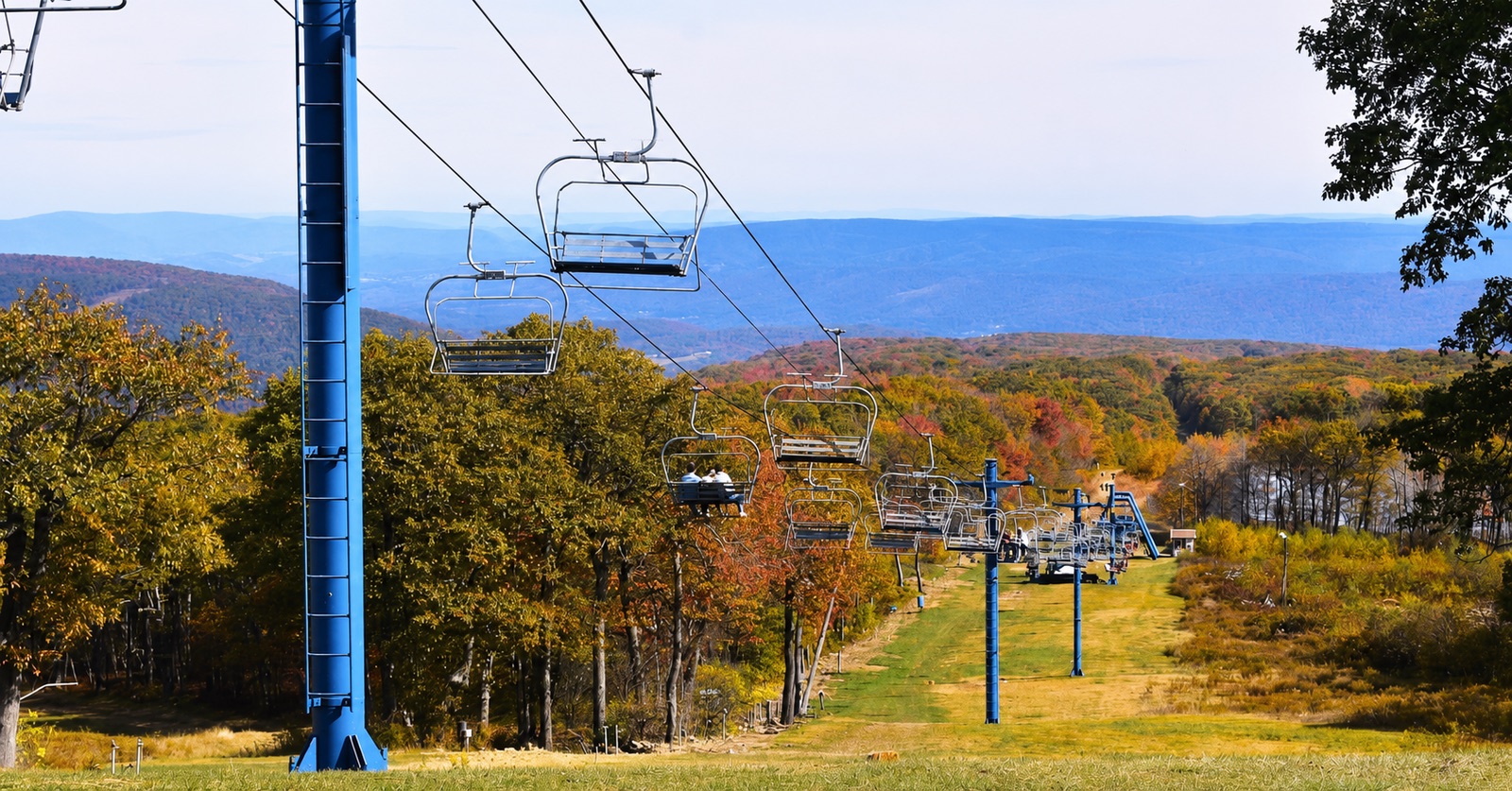 Chairlift rising over autumn foliage
